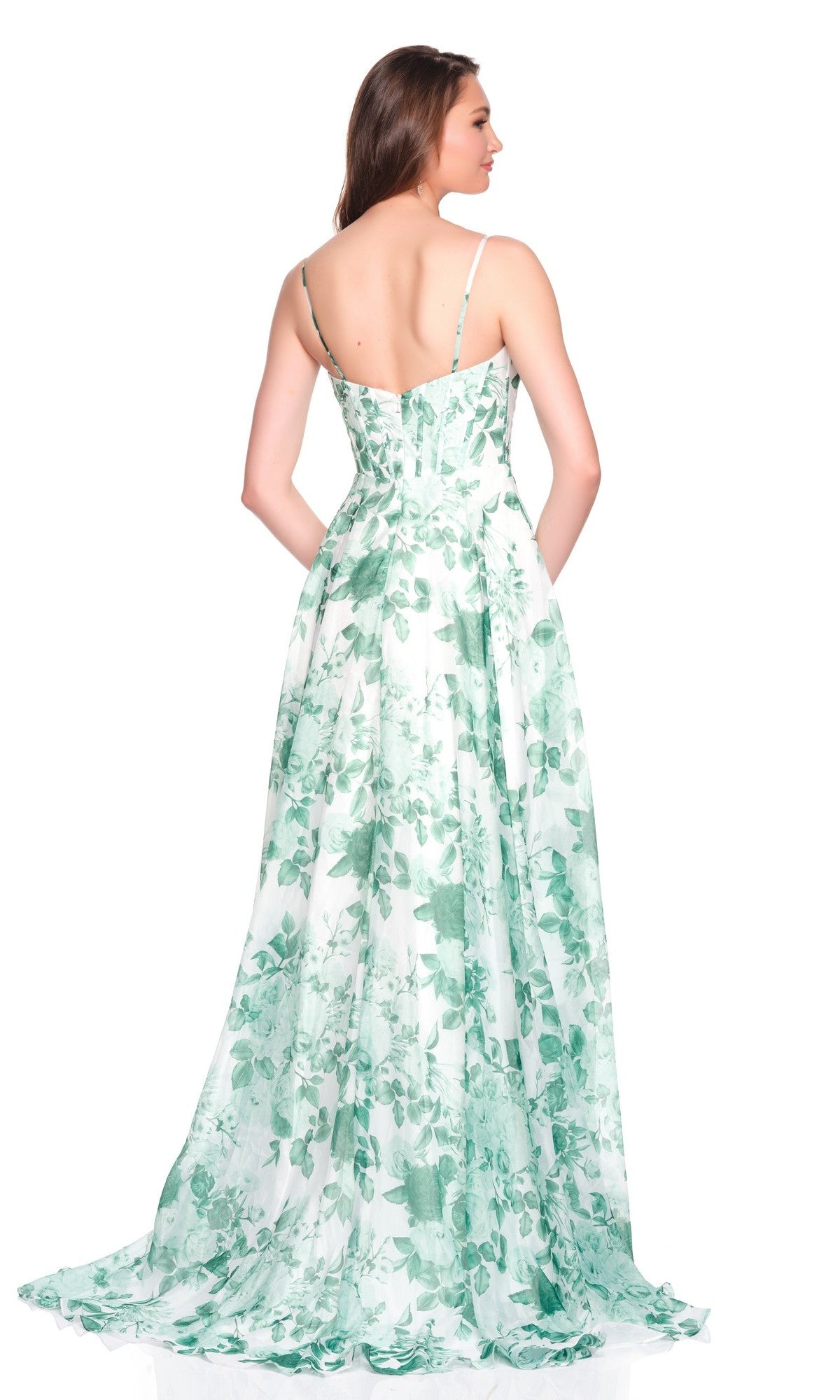 A woman poses with her back to the camera in the Dave and Johnny 12694 long prom dress, a sleeveless white A-line gown featuring a green floral print, set against a white background.